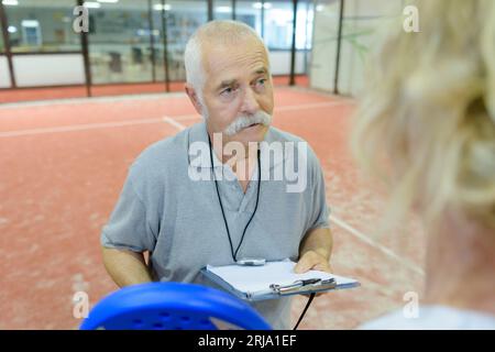 Entraîneur de tennis professionnel parlant à tenis player Banque D'Images