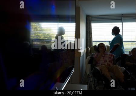 Lafrancaise, France. 22 août 2023. Les résidents se sont rassemblés dans la salle de télévision faiblement éclairée. Canicule, visite de la Résidence du Lac, à Lafrançaise, un ehpad (hébergement pour personnes âgées dépendantes) dans le Tarn et Garonne, en présence de Michel Weill, Président du Conseil départemental. France, la française le 22 août 2023. Photo de Patricia Huchot-Boissier/ABACAPRESS.COM crédit : Abaca Press/Alamy Live News Banque D'Images