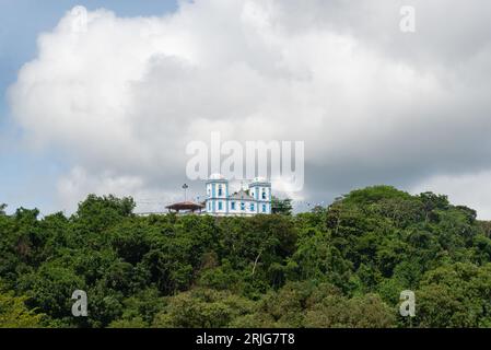 Valenca, Bahia, Brésil - 10 janvier 2023 : vue de l'église de Nossa Senhora do Amparo depuis le bord de la rivière una qui baigne le touriste c Banque D'Images