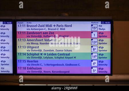 Departure board at Amsterdam Central Station in rainbow colors to support lhbtiq+ pride parade in the netherlands Stock Photo