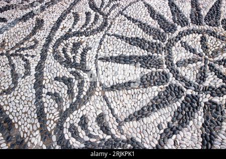 Rues populaires en mosaïque de galets de mer sur l'île de Symi en Grèce. Banque D'Images