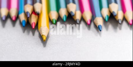 Colorful pencils laying in row. Multicolor group of cute wooden pencils. Stock Photo