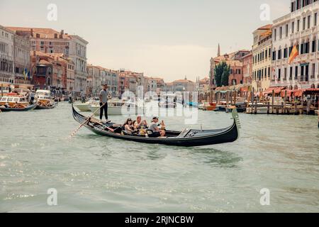 Un groupe de touristes divers profitant d'une promenade panoramique en gondole à travers le Grand Canal à Venise, en Italie Banque D'Images