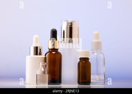 A lot of cosmetic bottles on a white table, an assortment of cosmetic bottles in the bathroom, healthy cosmetology, spa concept Stock Photo