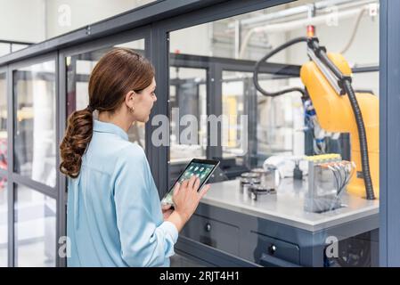 Businesswoman using digital tablet in high tech company Banque D'Images