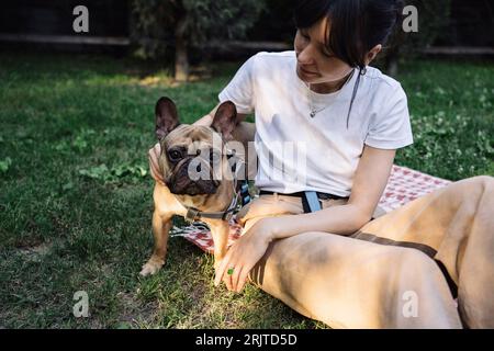 Femme caressant chien dans le parc Banque D'Images