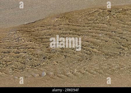 Patterns of waves and sand in Petroleum Creek on Shi Shi Beach, Olympic National Park, Washington State, USA Stock Photo