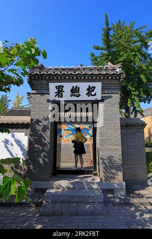 Qinhuangdao City, China - October 4, 2018: A girl is at the entrance of the ancient building's gate, Qinhuangdao City, Hebei Province, China Stock Photo