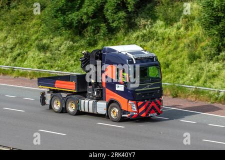 Camion United Utilities 2021 Rouge Noir Volvo FH. Un véhicule de grue de type dropside ; roulant à grande vitesse sur l'autoroute M6 dans le Grand Manchester, Royaume-Uni Banque D'Images