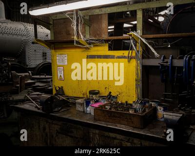 A close-up view of a workbench, featuring a variety of mechanical tools and equipment Stock Photo