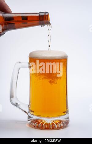 Beer being poured into a glass mug Stock Photo