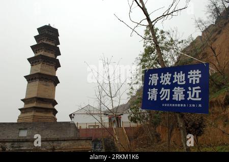 Bildnummer : 56365662 Datum : 21.11.2011 Copyright : imago/Xinhua (111121) -- XI AN, 21 novembre 2011 (Xinhua) -- Un panneau indiquant Landslide zone, Keep away est vu à côté de la tour Miaojue du temple Huayan à Xi an, capitale du nord-ouest de la Chine province de Shaanxi, 21 novembre 2011. Les deux tours millénaires du temple Huayan sont menacées depuis que plusieurs glissements de terrain se sont produits sur les collines entourant le temple au cours des derniers mois en raison de fortes pluies. Le socle de l'une des tours a été exposé en partie et le sol près de la tour s'est fissuré avec une crevasse de mètres de long. Comme Xi et continuer Banque D'Images