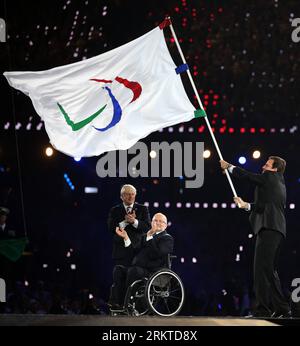 LONDRES, 9 septembre 2012 - le maire de Rio de Janeiro Eduardo Paes (à droite) tient le drapeau paralympique alors que le maire de Londres Boris Johnson (à gauche) et le président du Comité International paralympique (IPC) Philip Craven (à droite) applaudissent lors de la cérémonie de clôture des Jeux Paralympiques de Londres 2012 au Stade Olympique de Londres, Grande-Bretagne, 9 septembre 2012. (Xinhua/Wang Lili) GRANDE-BRETAGNE-LONDRES-JEUX PARALYMPIQUES-CÉRÉMONIE DE CLÔTURE PUBLICATIONxNOTxINxCHN Banque D'Images