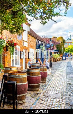 People enjoying wine al fresco at The Wine Yard in converted 16th century coaching inn courtyard Lion and Lamb Yard, Farnham, Surrey, England Stock Photo