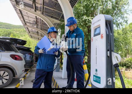 Jinan, province chinoise du Shandong. 31 mai 2023. Les techniciens vérifient l'équipement d'une station de recharge dans le village de Zhujiahu, dans le comté de Yiyuan, dans la province du Shandong, dans l'est de la Chine, le 31 mai 2023. Crédit : Zhu Zheng/Xinhua/Alamy Live News Banque D'Images