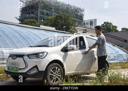 Jinan, China's Shandong Province. 24th Aug, 2023. A man with his electric car arrives at a greenhouse in Sanyuanzhu Village of Shouguang City, east China's Shandong Province, Aug. 24, 2023. Credit: Zhu Zheng/Xinhua/Alamy Live News Stock Photo