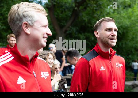 Hanover, Germany. 26th Aug, 2023. Per Mertesacker (r), former national soccer player, stands after the award of honorary sponsorship for the Rothschild giraffes to the Per Mertesacker Foundation at Hannover Zoo. Standing next to him is his brother Timo Mertesacker (l). Hannover Adventure Zoo and Per Mertesacker's foundation have been supporting each other for years in the areas of integration, learning support, environmental protection and species conservation. Credit: Michael Matthey/dpa/Alamy Live News Stock Photo