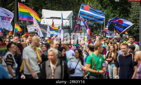 Bremen, Germany. 26th Aug, 2023. Participants of the Christopher Street Day (CSD) walk in Bremen with a flag and banners on the Osterdeich. For the demonstration procession through the Hanseatic city, the police expected 10,000 to 12,000 people. Credit: Focke Strangmann/dpa/Alamy Live News Stock Photo