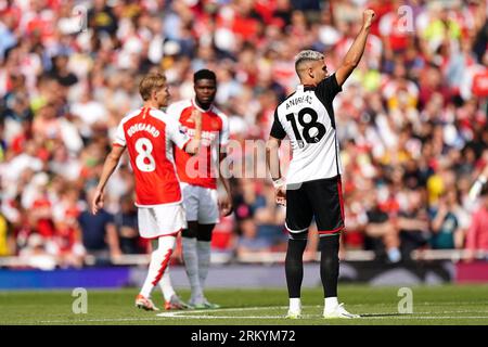 Fulham's Andreas Pereira (right) celebrates scoring their side's first goal of the game during the Premier League match at the Emirates Stadium, London. Picture date: Saturday August 26, 2023. Stock Photo