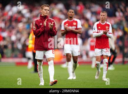 Arsenal's Martin Odegaard (left) applauds the fans after the final whistle in the Premier League match at the Emirates Stadium, London. Picture date: Saturday August 26, 2023. Stock Photo