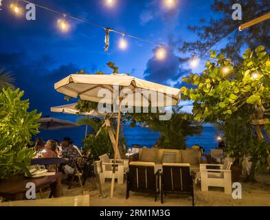 Grand Cayman, Cayman Islands, June 11th 2023, view of Tillie's at dusk, a restaurant on Seven Mile Beach Stock Photo