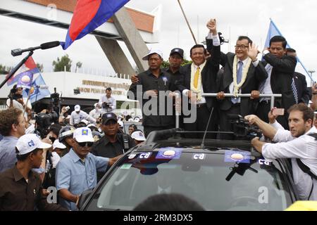 Bildnummer: 60155788  Datum: 19.07.2013  Copyright: imago/Xinhua (130719) -- PHNOM PENH, July 19, 2013 (Xinhua) -- Cambodia s opposition leader Sam Rainsy (man with glasses on pick-up vehicle) waves to his supporters at the Phnom Penh International Airport in Phnom Penh, Cambodia, July 19, 2013. Sam Rainsy returned to his homeland on Friday after spending nearly four years abroad in self-imposed exile to avoid an 11-year prison sentence on charges of disinformation and destruction of public property. (Xinhua/Sovannara) CAMBODIA-PHNOM PENH-OPPOSITION CHIEF-RETURN PUBLICATIONxNOTxINxCHN People P Stock Photo