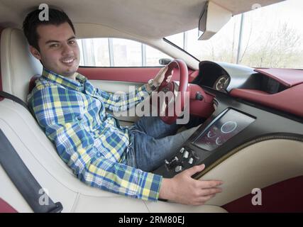 Propriétaire de la société de véhicules électriques Rimac Automobili, Mate Rimac pose dans son concept One supercar électrique lors d’une interview au siège de Rimac Automobili à Sveta Nedelja près de Zagreb, Croatie, le 21 mars 2014. Rimac Automobili est une entreprise croate qui développe et produit des véhicules électriques, des transmissions et des systèmes de batteries à haute performance. Le premier modèle de Rimac Automobili, le concept One, est connu comme le véhicule électrique de production le plus rapide au monde. Récemment, Rimac a commencé à coopérer avec plusieurs entreprises chinoises. (Xinhua/Miso Lisanin)(bxq) CROATIE-ZAGREB-RIMAC VÉHICULES ÉLECTRIQUES COMP Banque D'Images