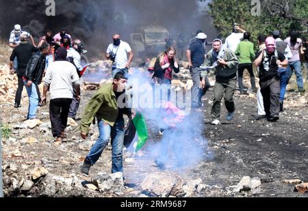 Des manifestants palestiniens fuient les gaz lacrymogènes tirés par des soldats israéliens lors d’une manifestation contre l’expansion des colonies juives dans le village de Kufr Qaddoum près de la ville de Naplouse en Cisjordanie le 9 mai 2014. (Xinhua/Ayman Nobani) MIDEAST-NAPLOUSE-AFFRONTEMENTS PUBLICATIONxNOTxINxCHN les manifestants PALESTINIENS fuient les gaz lacrymogènes TIRÉS par les soldats israéliens lors d'une manifestation contre l'expansion des colonies juives dans le village de Kufr près de la ville de Naplouse en CISJORDANIE LE 9 2014 mai XINHUA Ayman affrontements avec Nobani Mideast Naplouse PUBLICATIONxNOTxINxINxCHN Banque D'Images