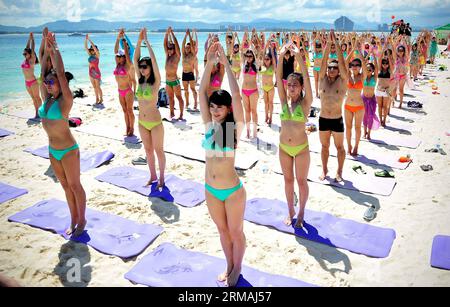(140712) -- SANYA, 12 juillet 2014 (Xinhua) -- des gens pratiquent le yoga lors d'un festival de bikini en bord de mer sur l'île de Wuzhizhou à Sanya, dans la province de Hainan du sud de la Chine, le 12 juillet 2014. (Xinhua/Guo Cheng) (lmm) CHINA-HAINAN-SANYA-SEASIDE-BIKINI FESTIVAL (CN) PUBLICATIONxNOTxINxCHN Sanya juillet 12 2014 XINHUA célébrités pratiquent le yoga lors d'un festival de bikini en bord de mer À Wuzhizhou Islande de Sanya South China S province de Hainan juillet 12 2014 XINHUA Guo Cheng lmm China Seaside bikini Festival Banque D'Images