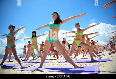 (140712) -- SANYA, 12 juillet 2014 (Xinhua) -- les gens pratiquent le yoga lors d'une énorme soirée bikini organisée sur l'île de Wuzhizhou à Sanya, dans la province de Hainan du sud de la Chine, le 12 juillet 2014. (Xinhua/Guo Cheng)(wjq) CHINA-HAINAN-SANYA-SEASIDE-BIKINI FESTIVAL (CN) PUBLICATIONxNOTxINxCHN Sanya juillet 12 2014 XINHUA célébrités pratiquent le yoga lors d'une fête massive de bikini héros AU Wuzhizhou Islande à Sanya South China S Hainan province de Hainan Chine juillet 12 2014 XINHANYA Seaside bikini Festival CN Banque D'Images