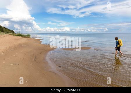 Randonneur touristique explorant la belle plage de sable Kauksi sur le lac Peipus sur la journée calme d'été en Estonie, Banque D'Images