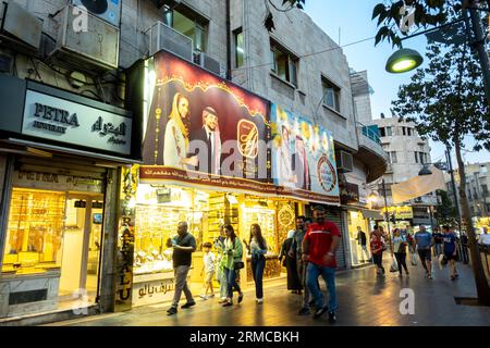 Touristes, habitants marchant sur la rue principale à Amman Jordanie devant les magasins Jewellry et les panneaux d'affichage de mariage Prince Banque D'Images