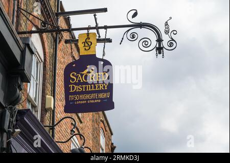 Enseigne suspendue ornée au-dessus de la Sacred Distillery, Bottle Shop & Tasting Room sur Highgate High Street, Highgate Village, Londres, Angleterre, Royaume-Uni Banque D'Images