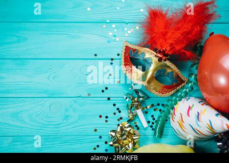 Fête chapeau ballon avec confetti mascarade doré masque de carnaval table en bois Banque D'Images