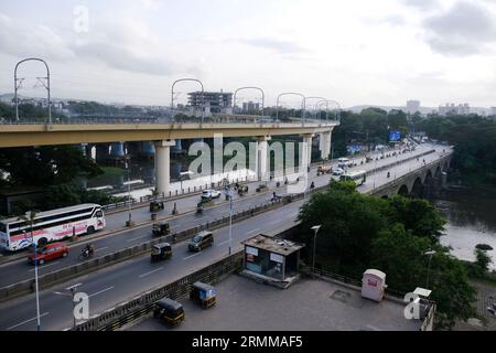 10 août 2023, Pune, Maharashtra, Inde - la circulation se déplace sur la route de la ville de Pune avec un beau ciel de soirée en arrière-plan. Banque D'Images