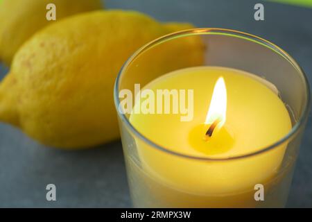 yellow color candle and lemon on black background  Stock Photo