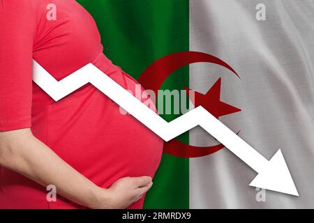 Pregnant woman on Algerian flag background. Falling fertility rate Stock Photo