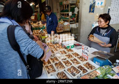 Tokyo, Japon - 21 mai 2023 : femme senior japonaise vendant des champignons matsutake frais à un client pour cuisiner de délicieux plats célèbres en automne au légume Banque D'Images