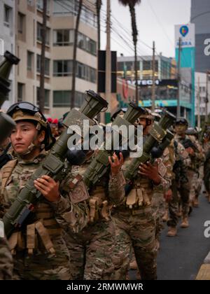 Lima, Peru - July 29 2023: Young Peruvian Women and Men in Camouflage Uniforms March with Weapons in the Independence Day Military Parade Stock Photo