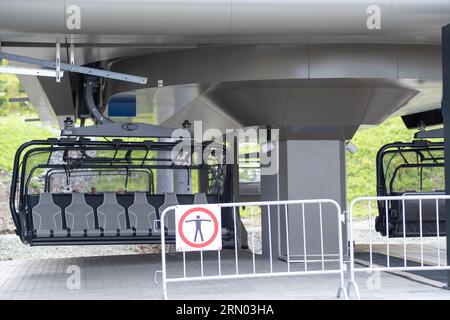 Place of landing in the cabin of the cable car. Close-up of a chairlift cab on the background of mountains and forests. Cable car trip to viewpoints i Stock Photo