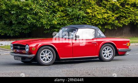 Whittlebury,Northants,UK -Aug 27th 2023 : 1972 voiture rouge Triumph TR6 voyageant sur une route de campagne anglaise Banque D'Images