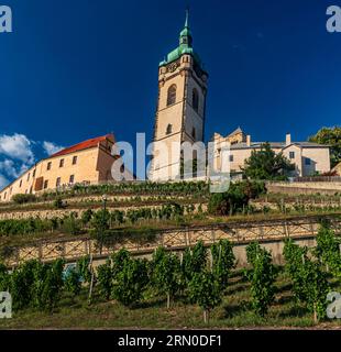 Melnicke terasy with castle and church Melnik above in Czech republic during summer evening with clear sky Stock Photo