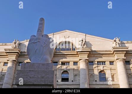 'Il dito medio' une sculpture en marbre du doigt du milieu par Maurizio Cattelan en face du bâtiment de la Bourse (Palazzo Mezzanotte), Piazza Affari, Milan Banque D'Images