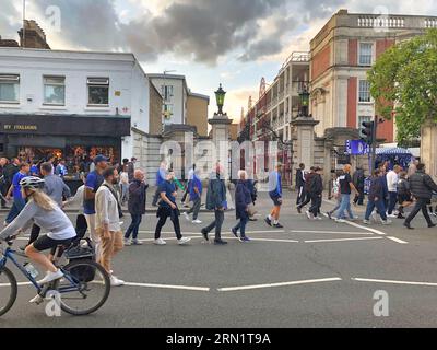 30 août 2023 Fulham, Londres, Royaume-Uni les fans et supporters du Chelsea football Club marchent vers le match contre Wimbledon AFC devant les Sir Edward Stoll Foundation Mansions - le logement des vétérans à côté du Stamford Bridge Stadium. Cet emplacement est sujet à un rachat par Todd Bohley, le propriétaire du Chelsea football Club. Banque D'Images