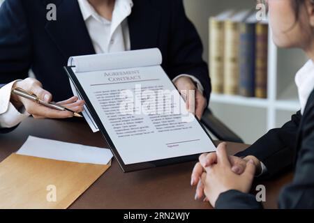 Close up of businessman or lawyers discussing about signing his signature on contract Stock Photo