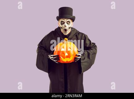 Frightening crazy man in masquerade costume frightfully exclaims frighteningly on Halloween. Stock Photo
