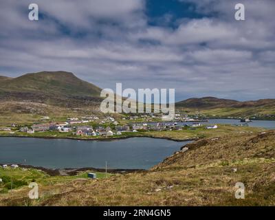 The village of Castlebay on the island of Barra in the Outer Hebrides, Scotland, UK. Taken looking northeast with the hill of Heaval, the highest poin Stock Photo