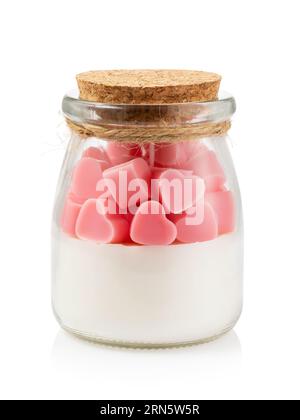 Scented candle with various fillings in a transparent glass jar isolated on a white background Stock Photo