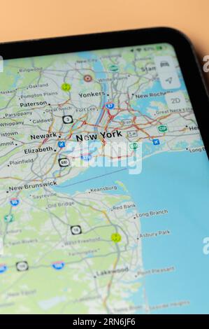 New York, USA - August 24, 2023: Car traffic in New York on google maps app on tablet screen close up view Stock Photo