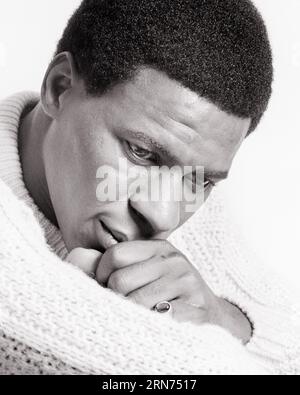 1970s PORTRAIT OF THOUGHTFUL SAD AFRICAN-AMERICAN MAN LOOKING DOWN S HAND TO MOUTH WEARING CABLE KNIT SWEATER  - p7936 HAR001 HARS KNIT SADNESS DREAMS HEAD AND SHOULDERS AFRICAN-AMERICANS AFRICAN-AMERICAN REFLECTIVE THINK BLACK ETHNICITY MOOD REFLECTING PONDER PONDERING CONSIDER LOST IN THOUGHT GLUM CONTEMPLATIVE CABLE KNIT MEDITATE MEDITATIVE MID-ADULT MID-ADULT MAN MISERABLE BLACK AND WHITE CABLE CONSIDERING HAR001 OLD FASHIONED AFRICAN AMERICANS Stock Photo